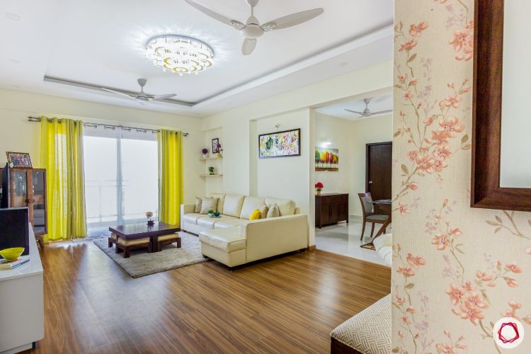 top-interior-designers-in-bangalore-living-room-wooden-flooring-sofa-curtain