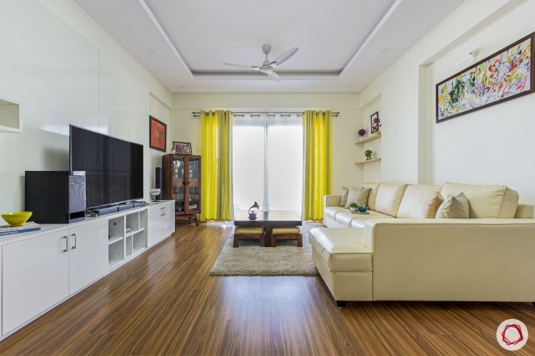 top-interior-designers-in-bangalore-living-room-wooden-flooring-sofa-curtain-TV-unit