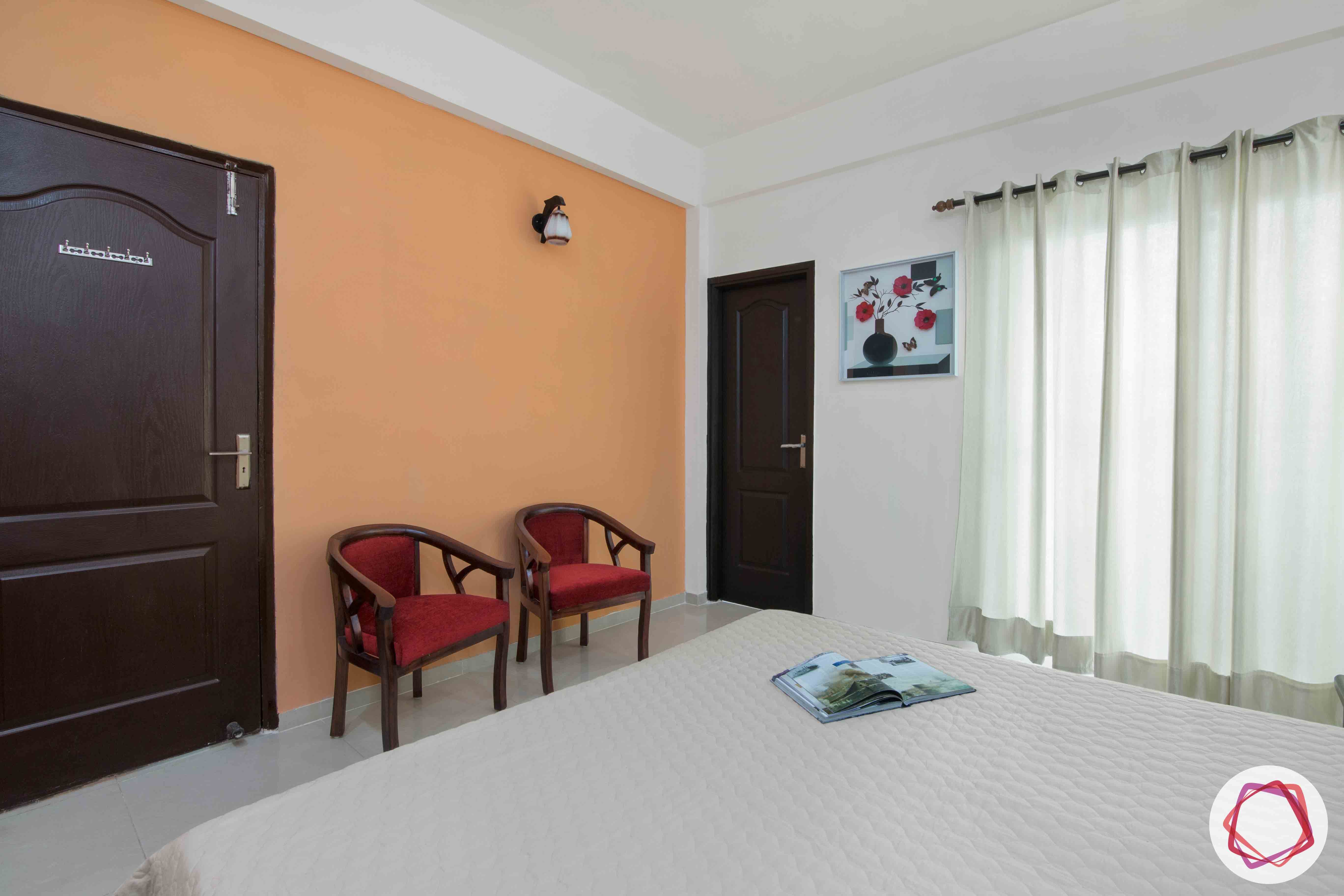 3bhk flat interior design-orange accent wall-red chair designs