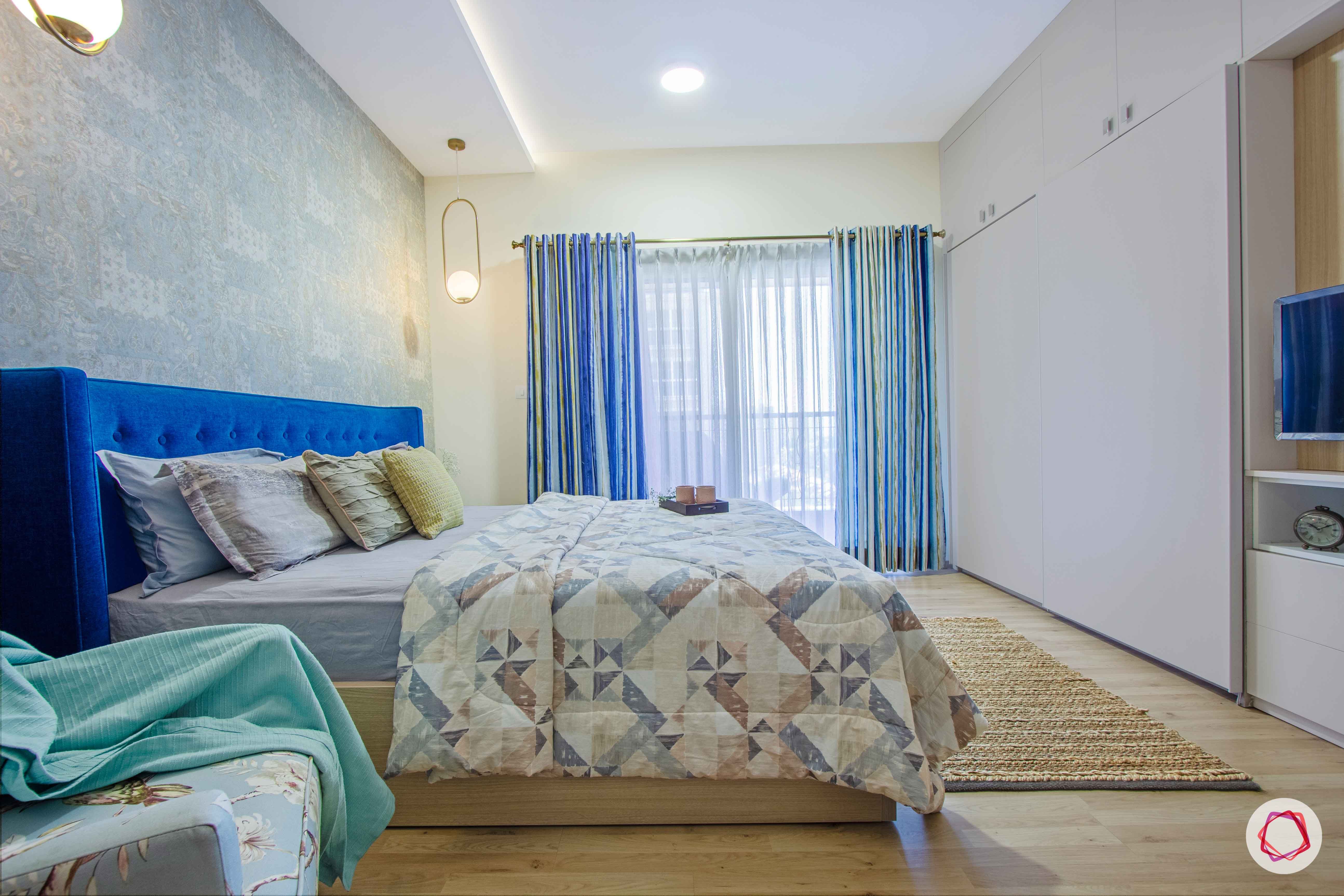 master-bedroom-blue-wallpaper-headboard-wardrobe