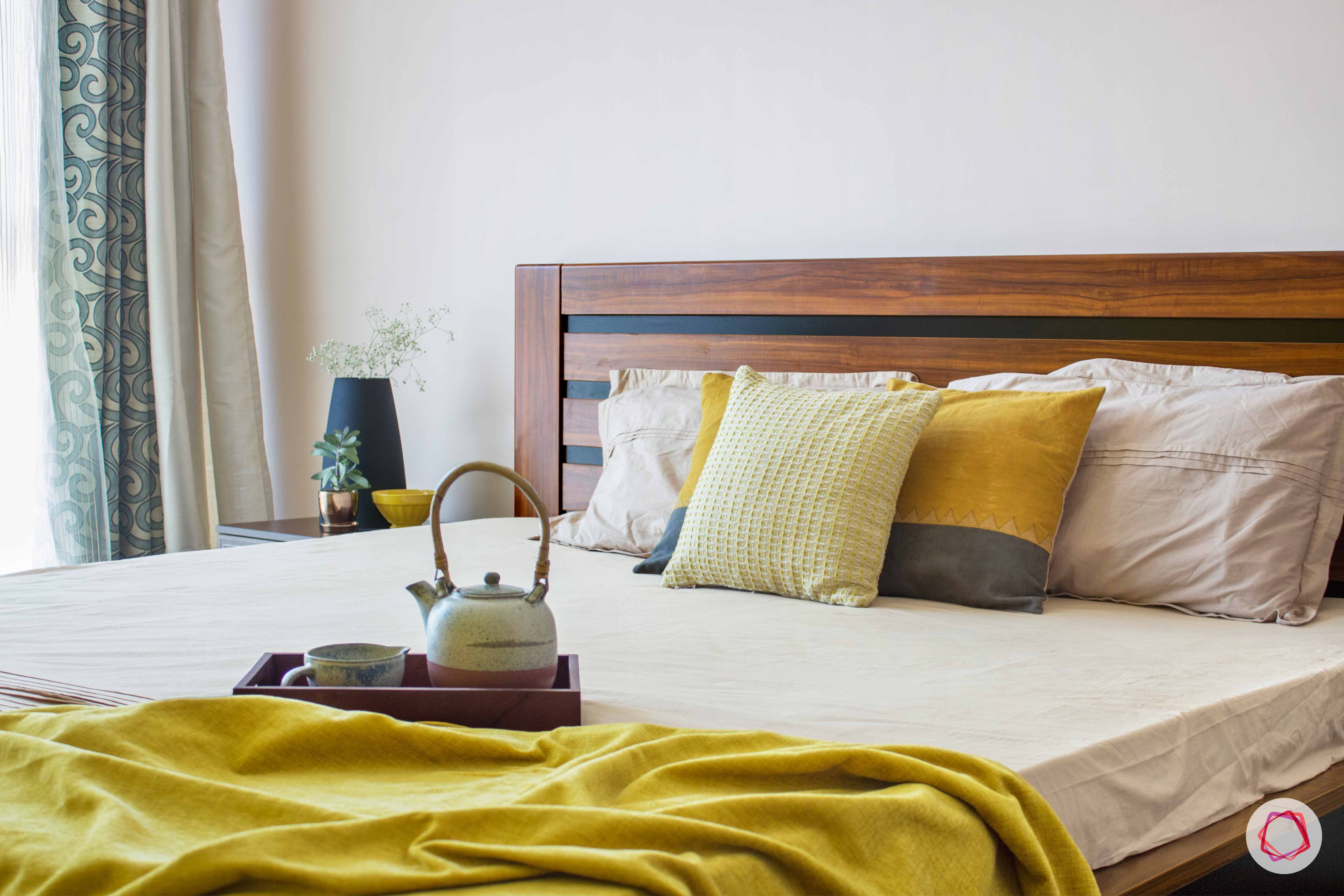 snn raj greenbay-master bedroom-yellow throw-wooden bed-cushions