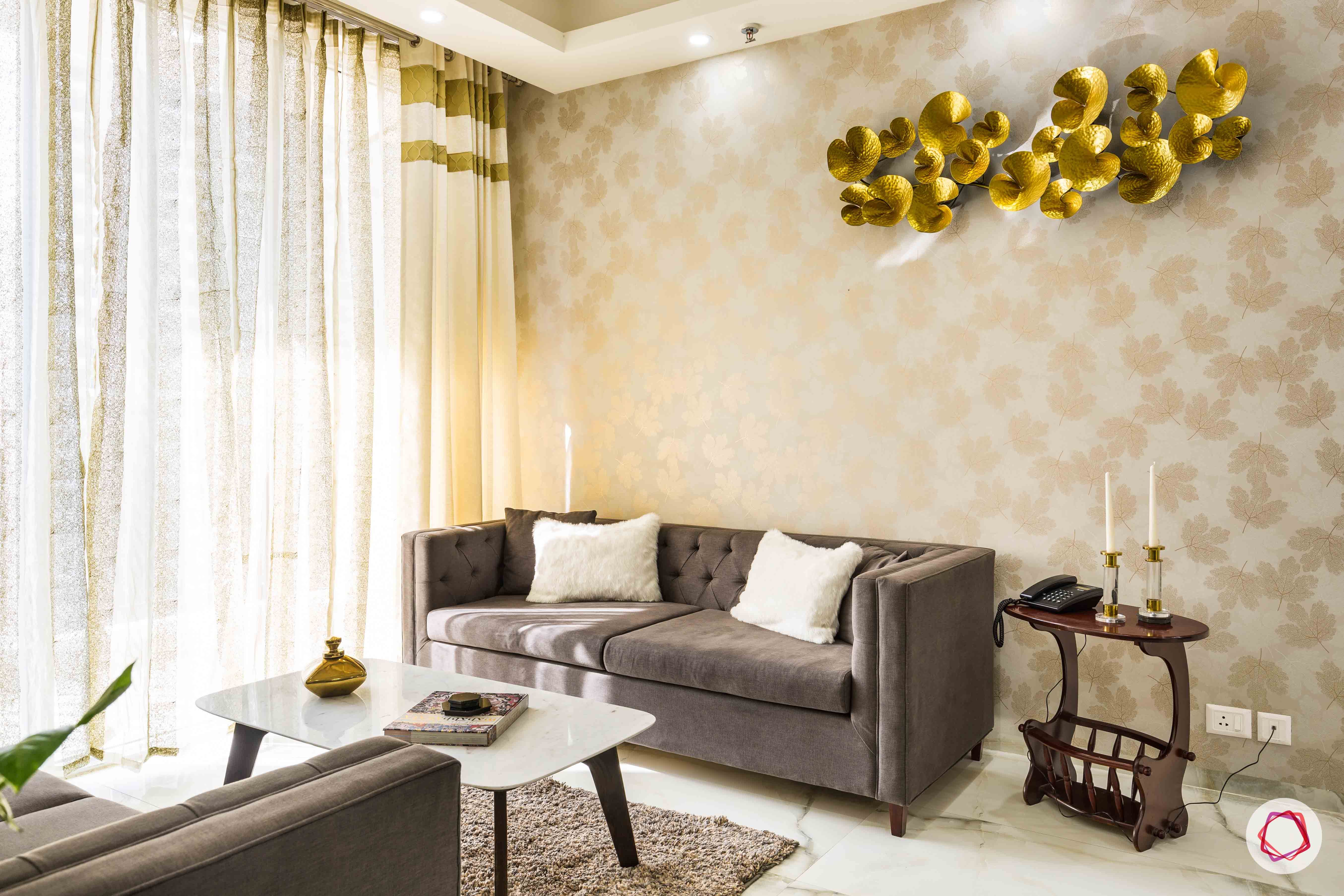 Nirala-Aspire-living-room-grey-sofa-gold-accent-curtains-coffee-table