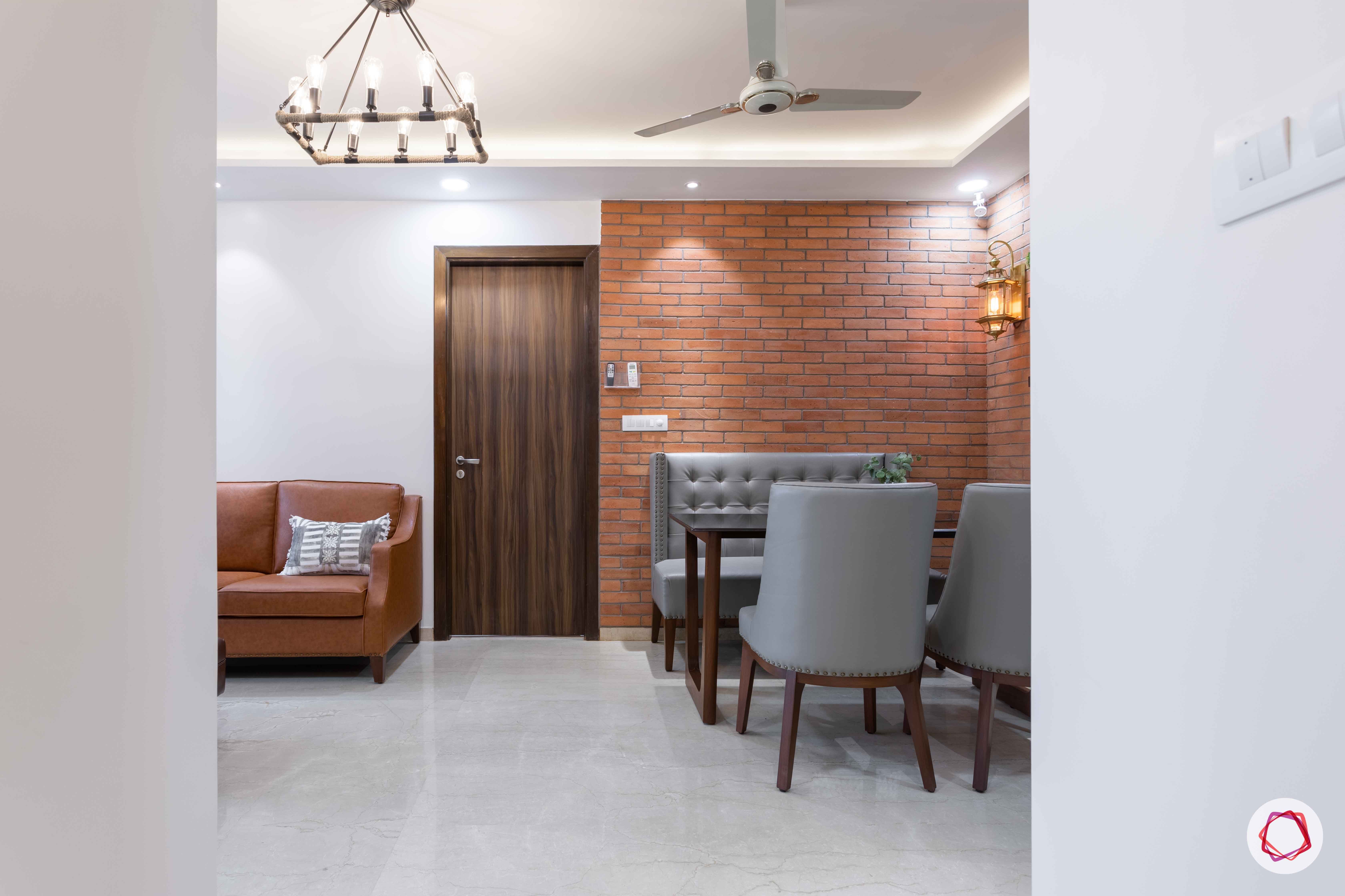 adani western-heights-exposed brick wall designs-four-seater dining set designs