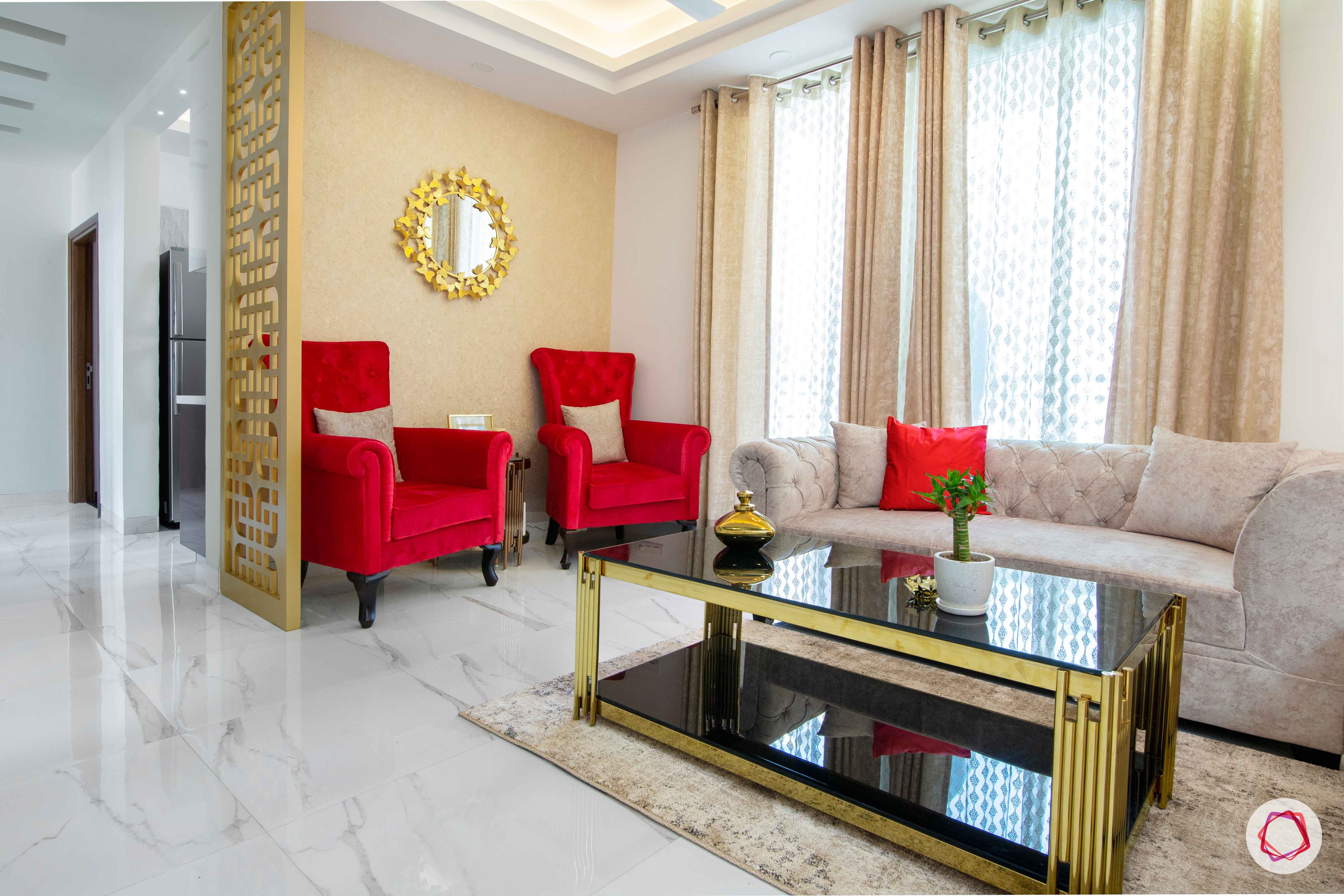 tdi ourania_living room_red accent chairs_golden mirror_golden wallpaper