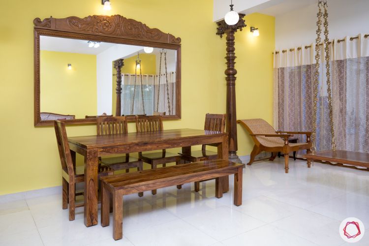 vastu shastra for house_mirror_dining room_wooden dining table_yellow wall