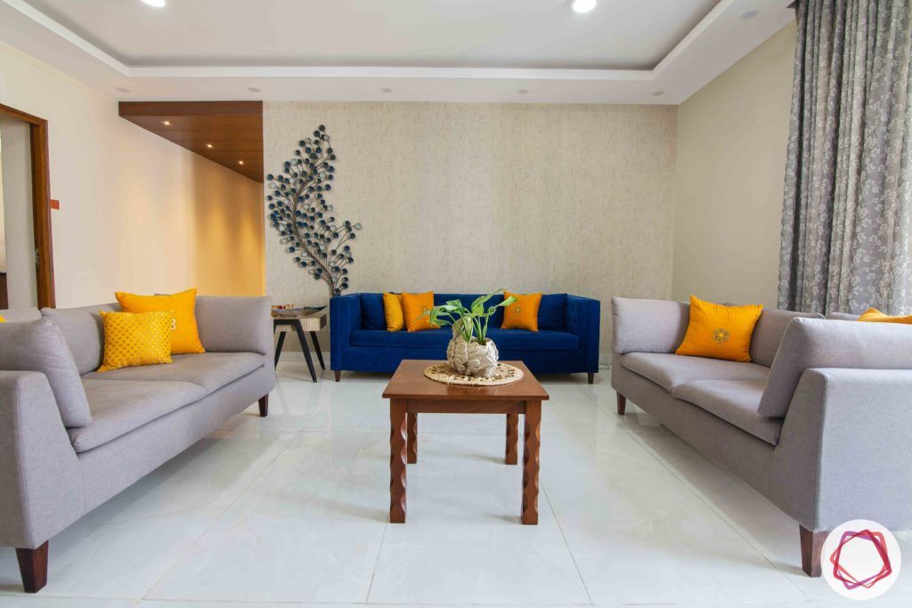 Shipra Srishti-living-room-blue-yellow-sofa-pillows-floral-accent