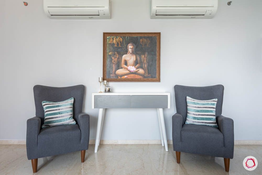 oberoi goregaon-console table-grey chairs-buddha painting