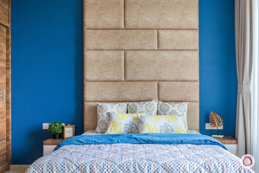 oberoi goregaon-master bedroom-blue wall-suede headboard