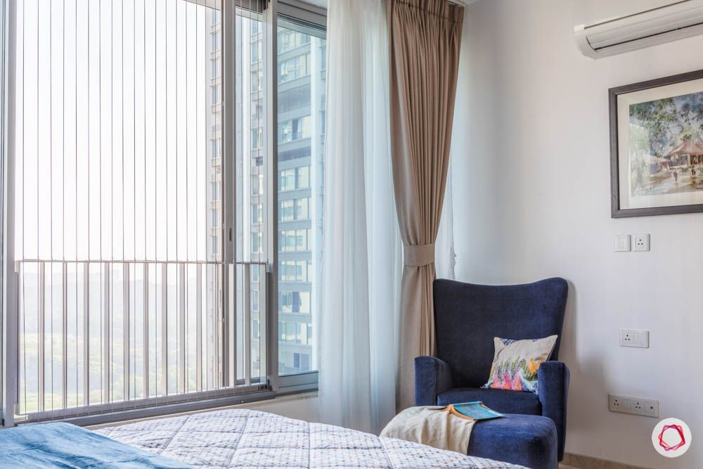 oberoi goregaon-master bedroom-reading corner-blue wing chair-footrest