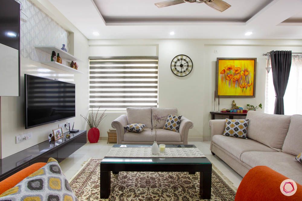 Vaswani Brentwood-living-room-sofas-orange-grey-throw-pillows-coffee-table-clock-painting