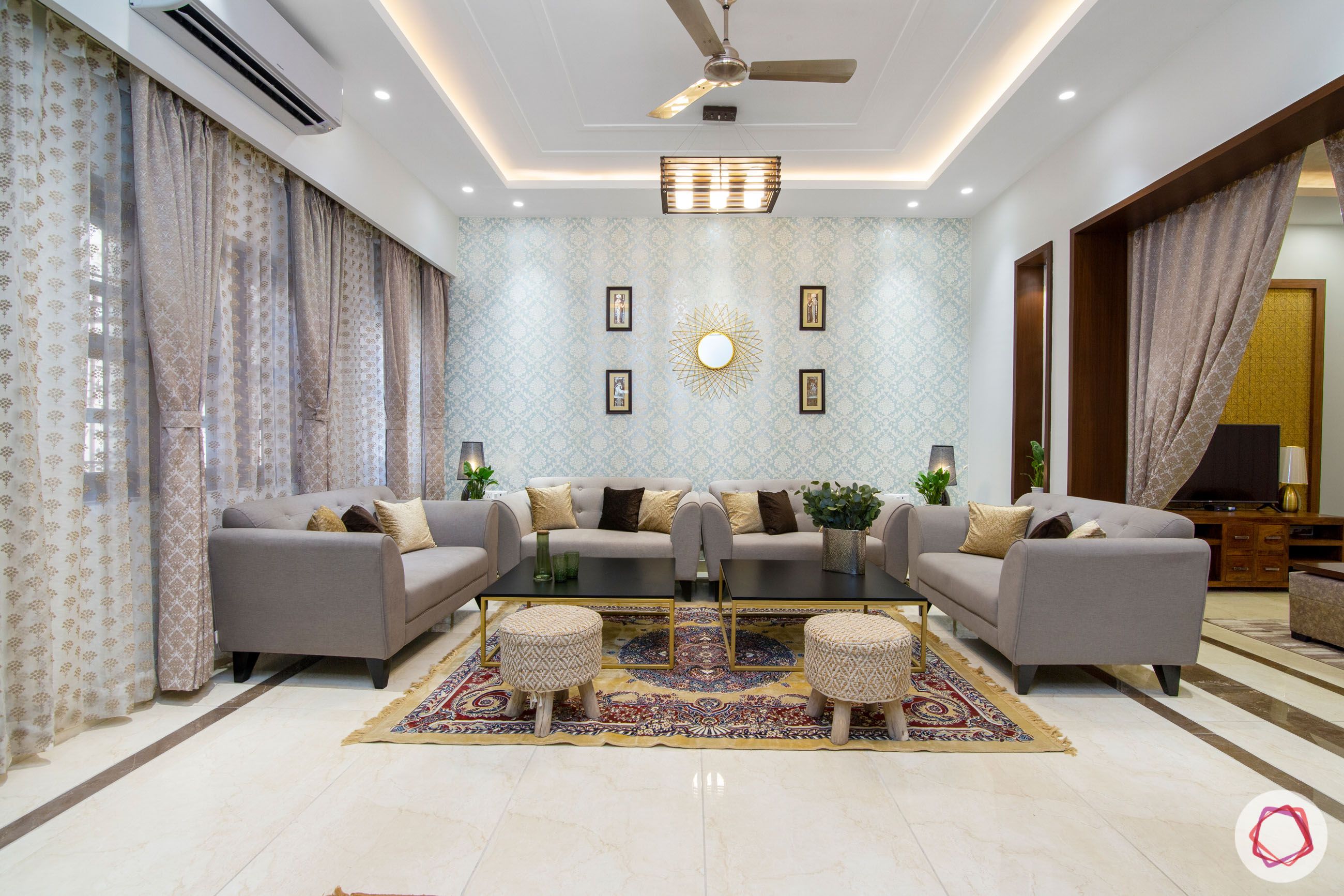 indian living room-gold ottomans-blue wallpaper