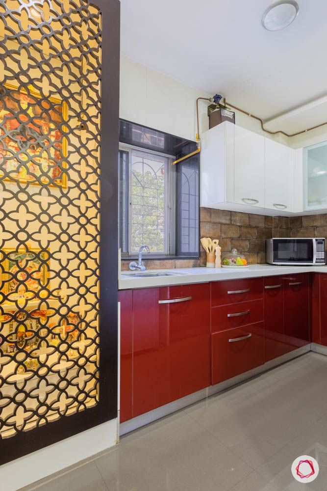jali design-kitchen-pooja-door-red-cabinets-white-countertop-microwave