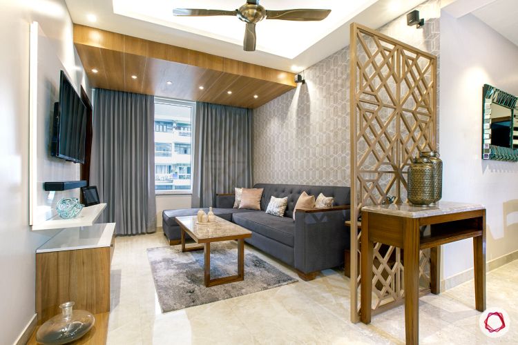 jali-design-gold-grey-sofa-false-ceiling-spotlights-coffee-table-TV