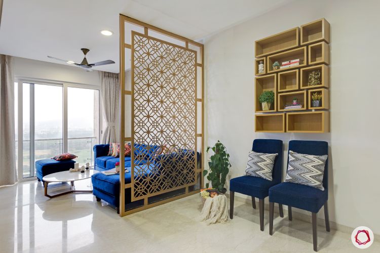 jali-design-gold-living-room-blue-sofa-chairs-shelf-coffee-table
