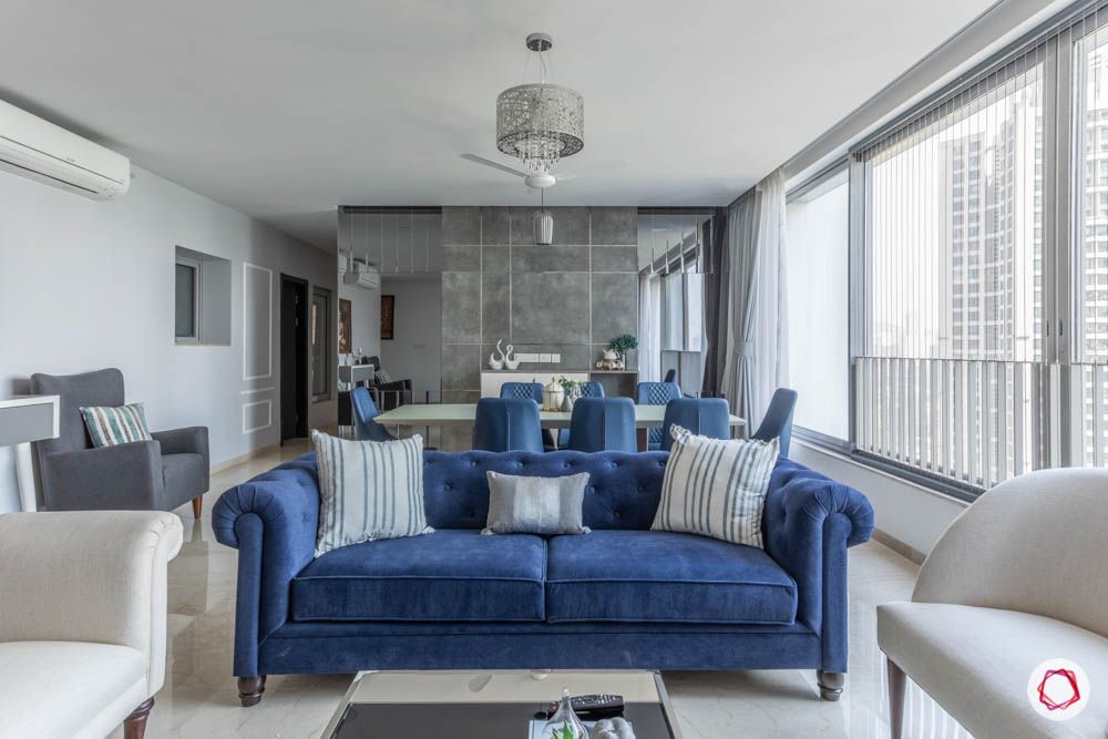 grey-blue-living-room-sofas-pillows-windows-accent-wall-armchair