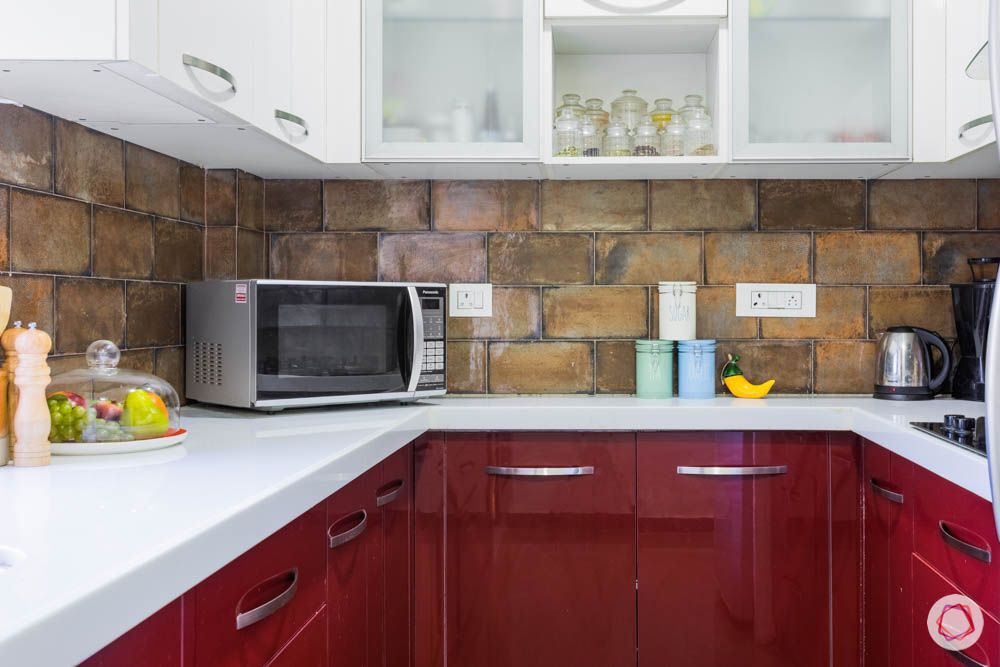 brick wall texture-red kitchen cabinets
