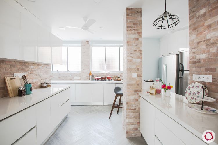 marble-design-kitchen-countertop-white-cabinets-exposed-brick