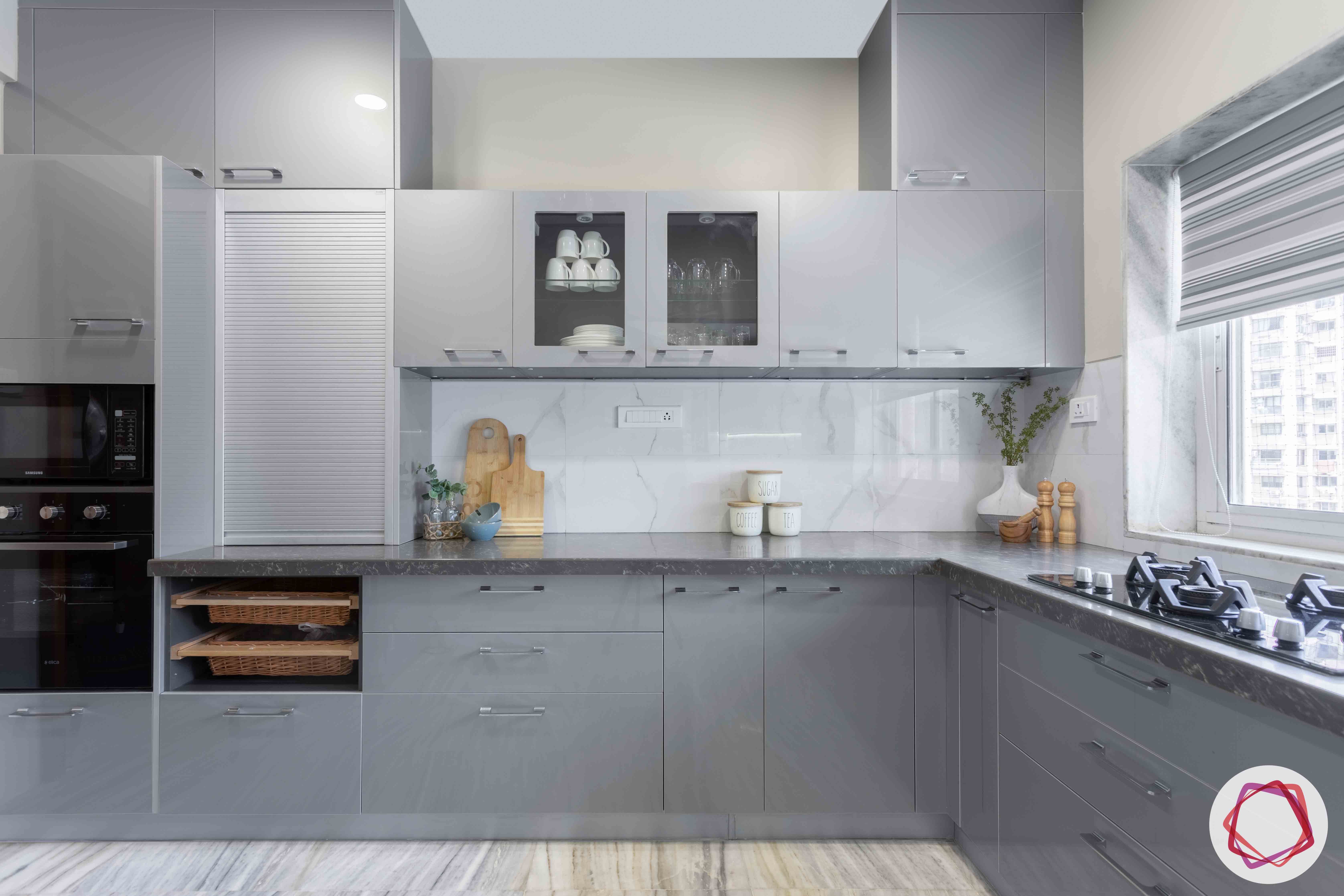 marble-backsplash-grey-kitchen-cabinets-wicker-baskets-stove