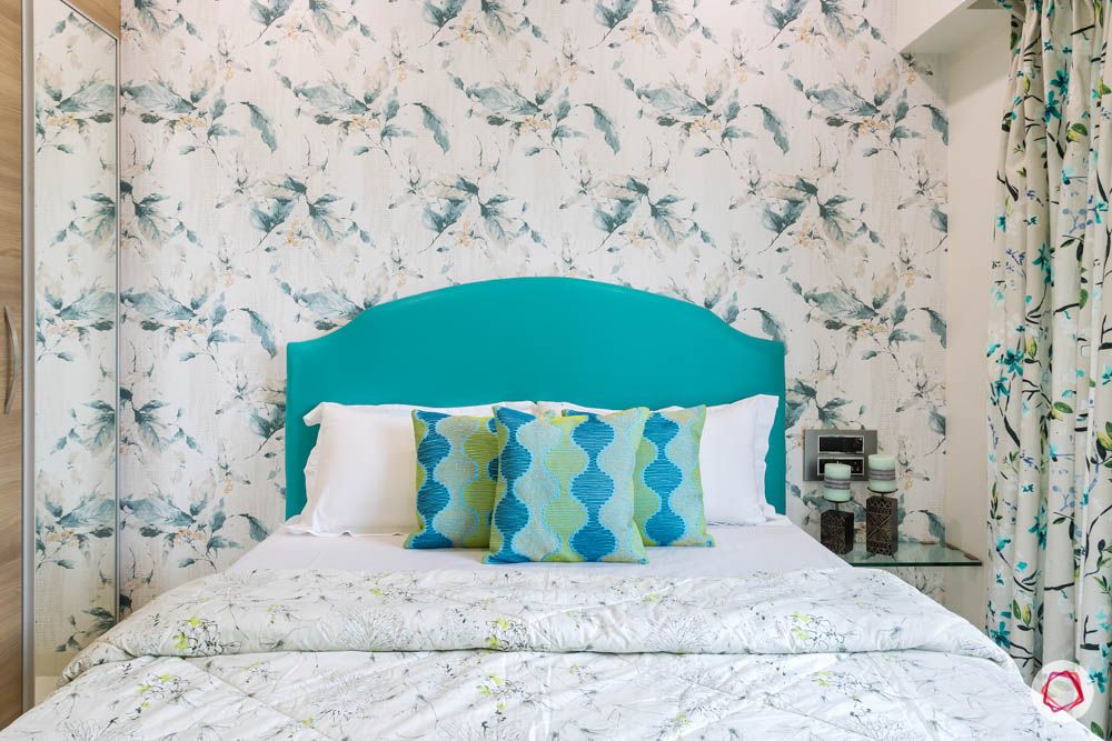 4 bhk flat in mumbai-guest bedroom-bed-blue upholstered headboard-floral wallpaper