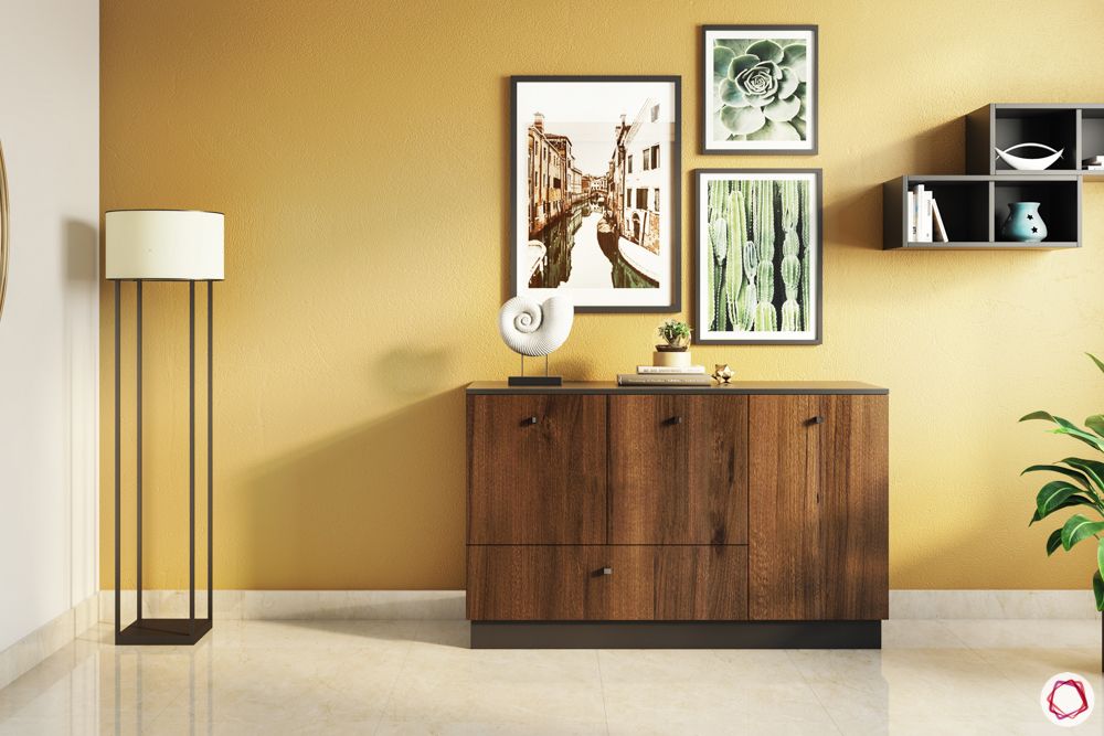 foyer-area-design-wooden-console-table-yellow-wall-frames-floor-lamp