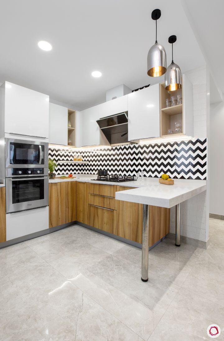 how to make a kitchen look brighter-recessed lights-white kitchen cabinets-breakfast counter