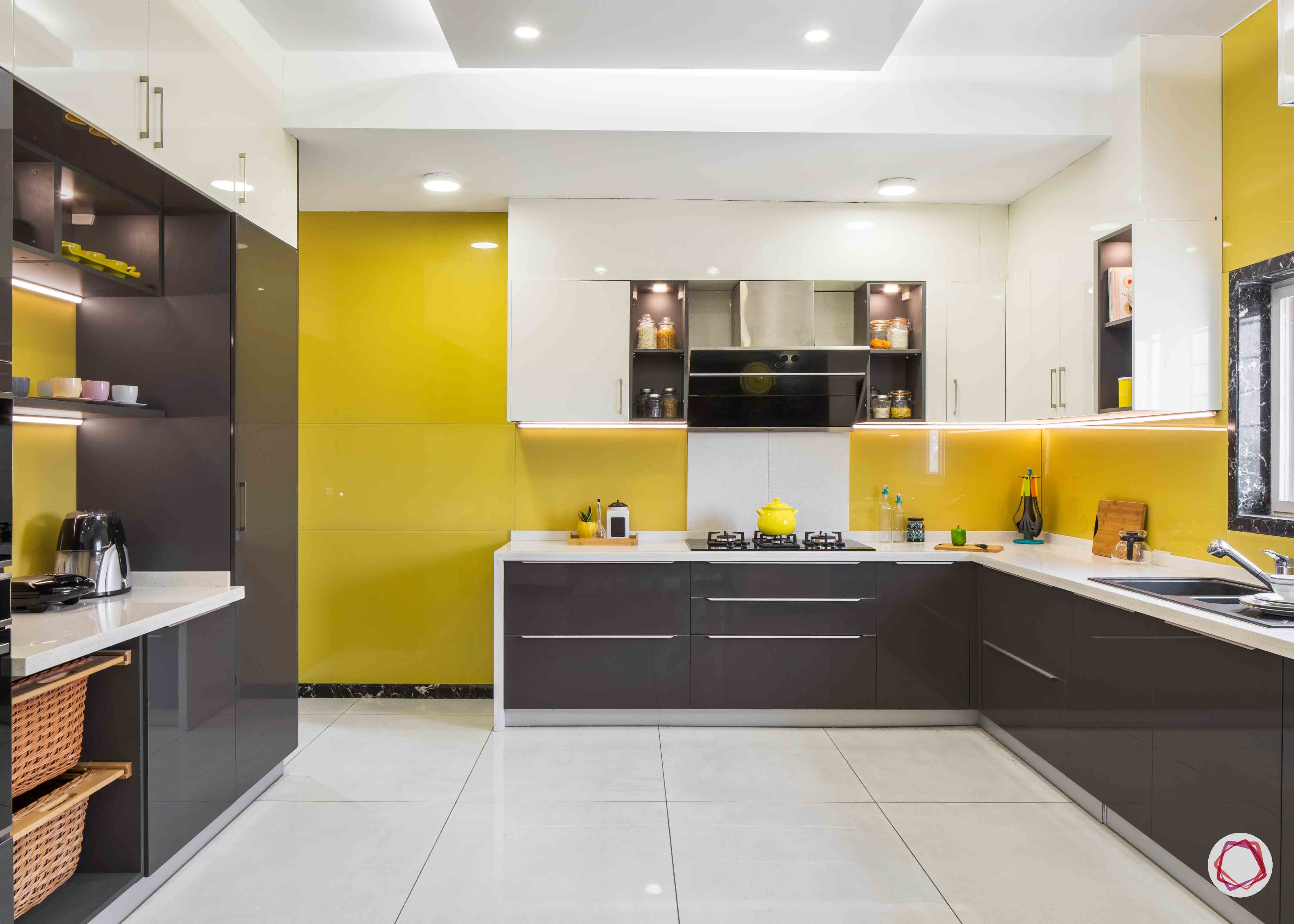 https://jumanji.livspace-cdn.com/magazine/wp-content/uploads/2019/10/13123716/Modular-Kitchen-Design-Images-Yello-Lacquered-Glass-Backsplash1.jpg