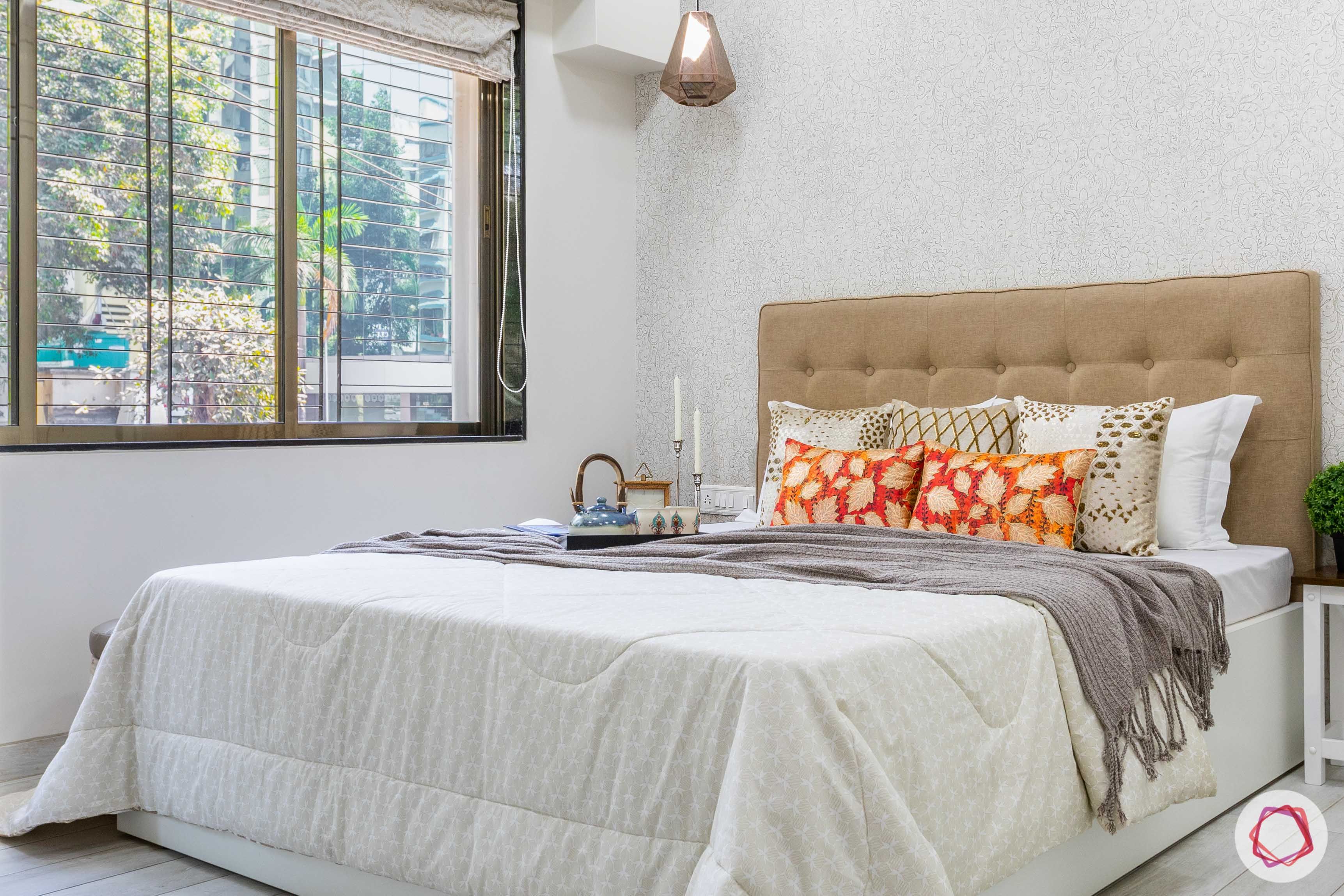 interior design company in mumbai-silver wallpaper-golden headboard-master bedroom-pendant light-window grills