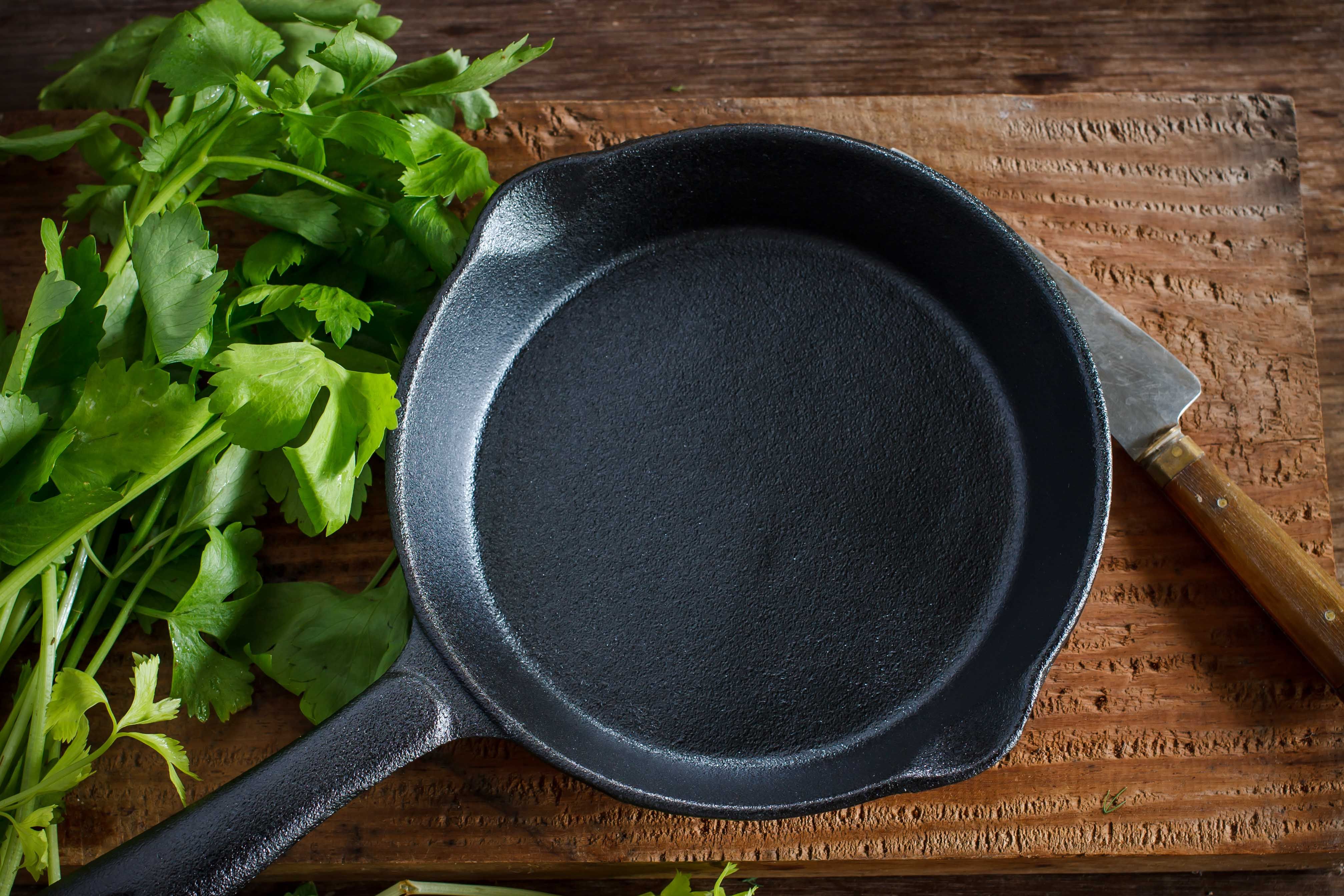 cast iron pan-coriander-knife-wooden-board