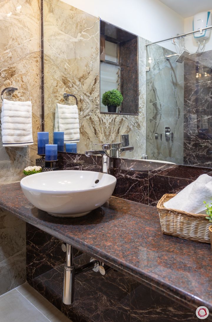 bathroom-rust-like-counter-white-sink-basket-towel