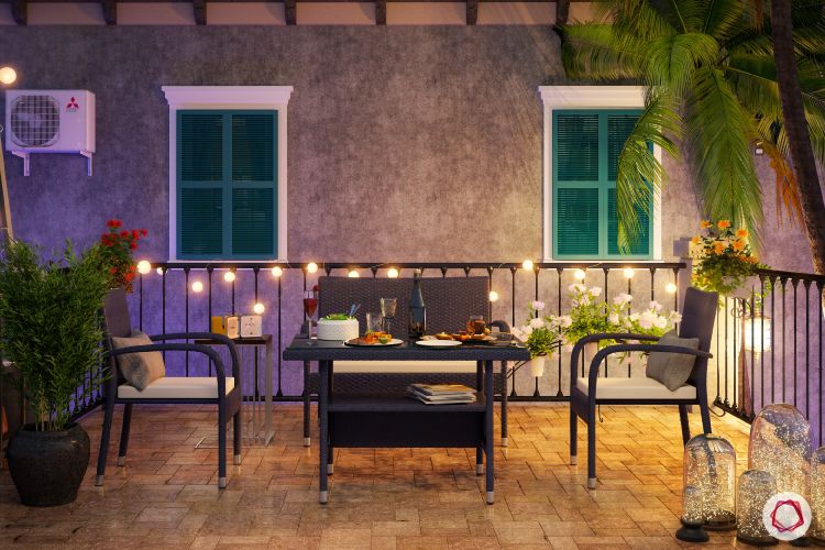 flat balcony ideas-fairy lights-coffee table-chairs