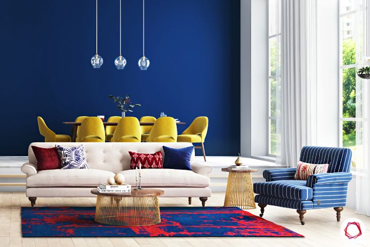yellow chairs-blue accent chair-carpet-pendant lights