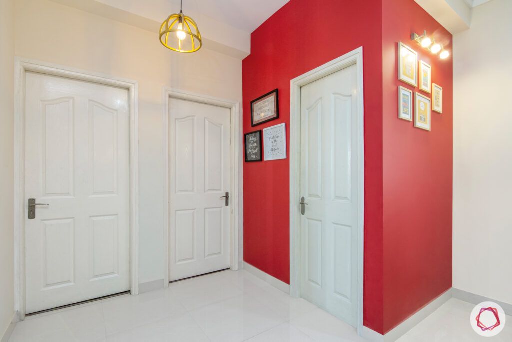 mapsko royale ville-red walls-white doors-pendant lighting-frames-white walls