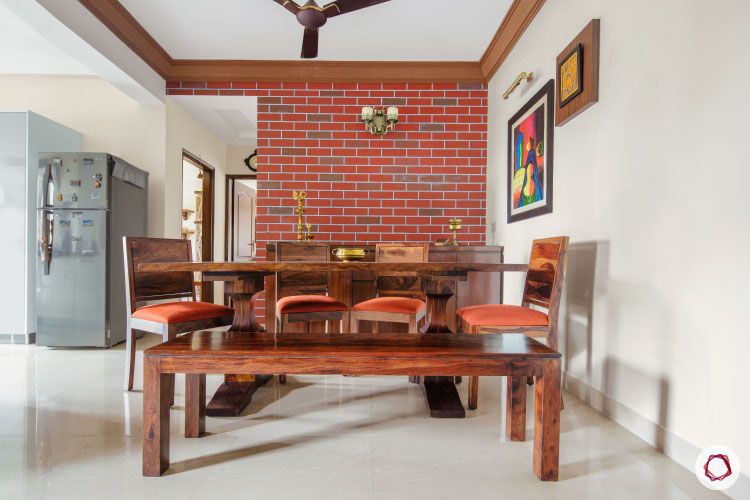 cream walls and dark wood furniture-wooden dining table-brick wall-wall art-wooden bench