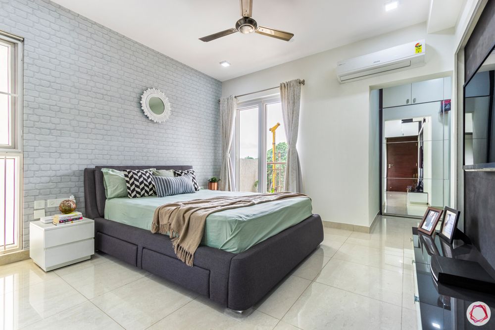 apartment interior-master bedroom-exposed brick wallpaper-mirror-dresser