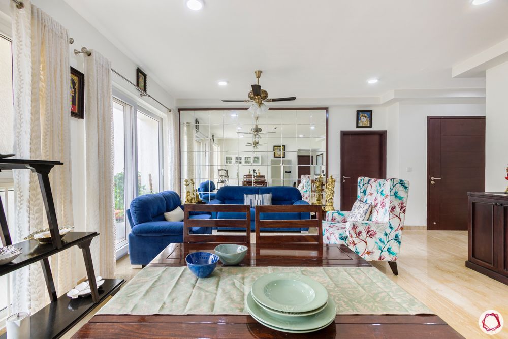 apartment interior-living room-mirror wall-blue sofa-accent chair