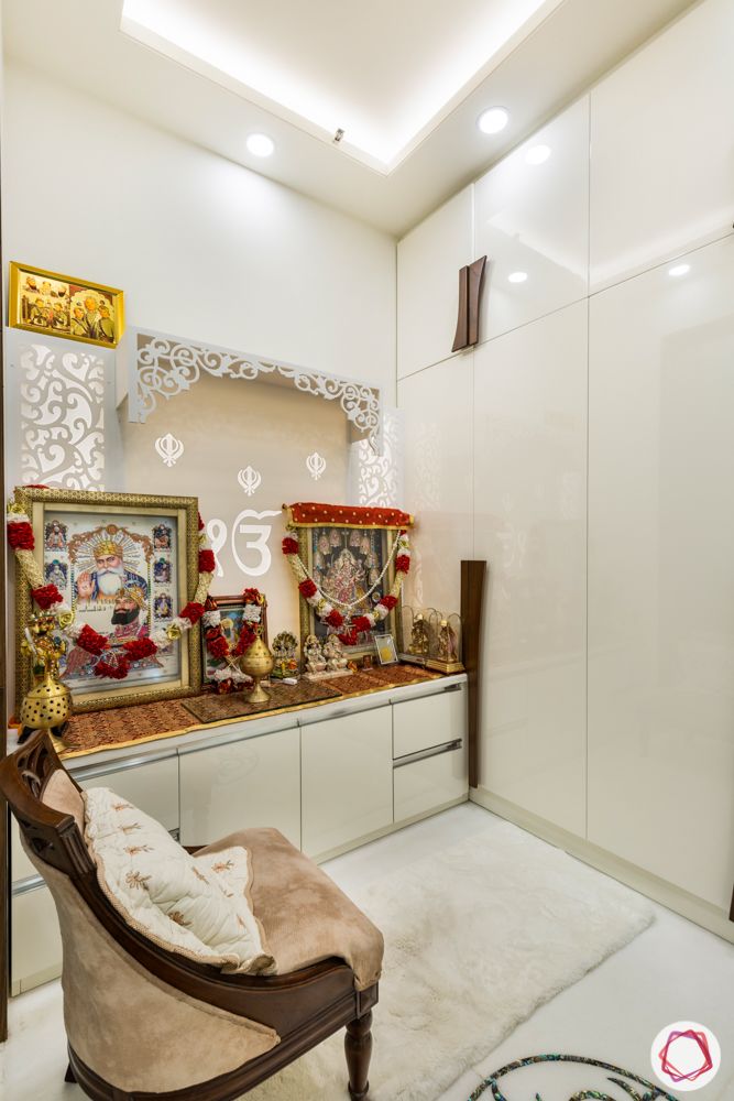 pooja mandir for home designs-white cabinets-high-gloss wardrobes-chair in pooja room