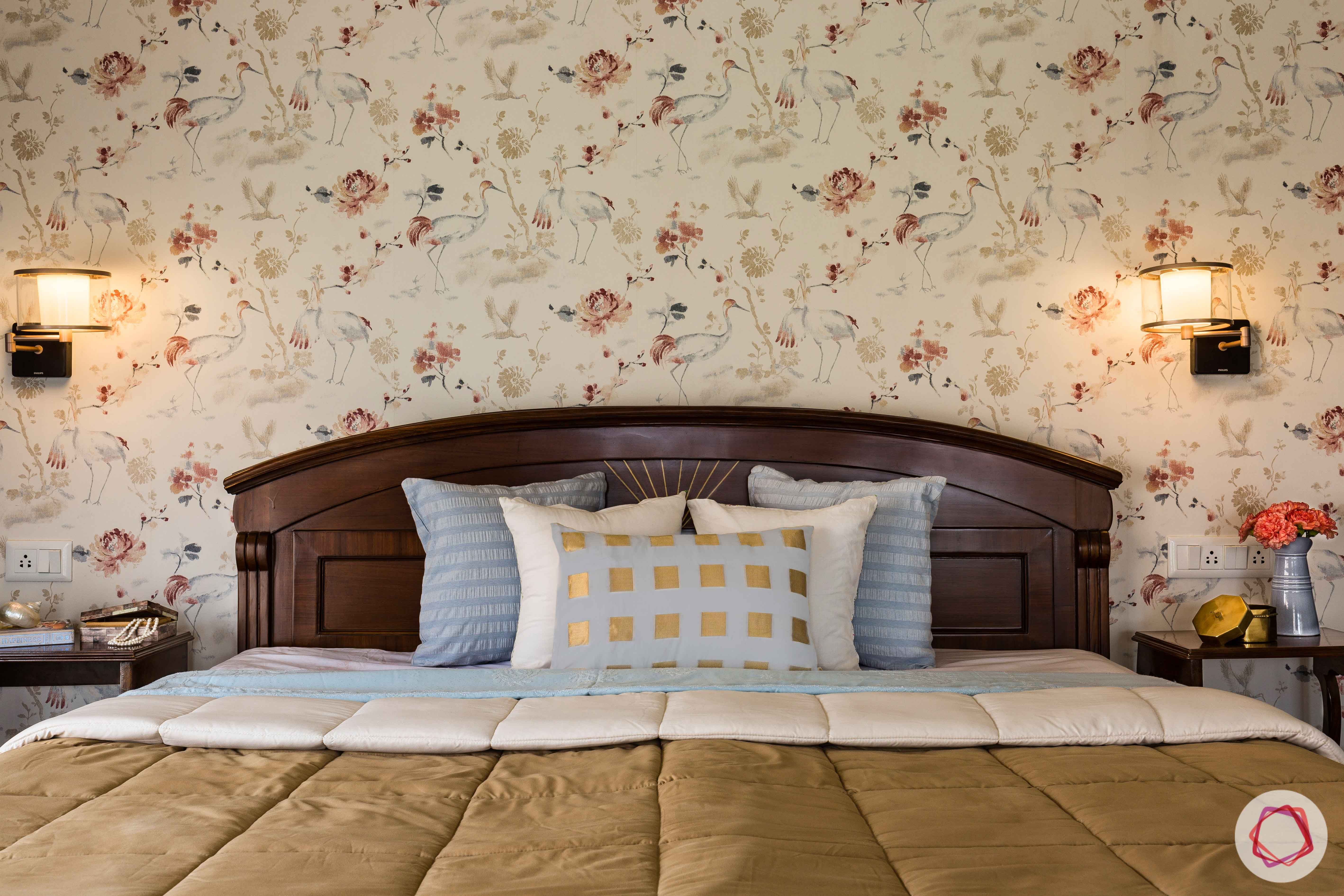 bedroom accent wall-floral wallpaper-solid wood bed-wall sconces