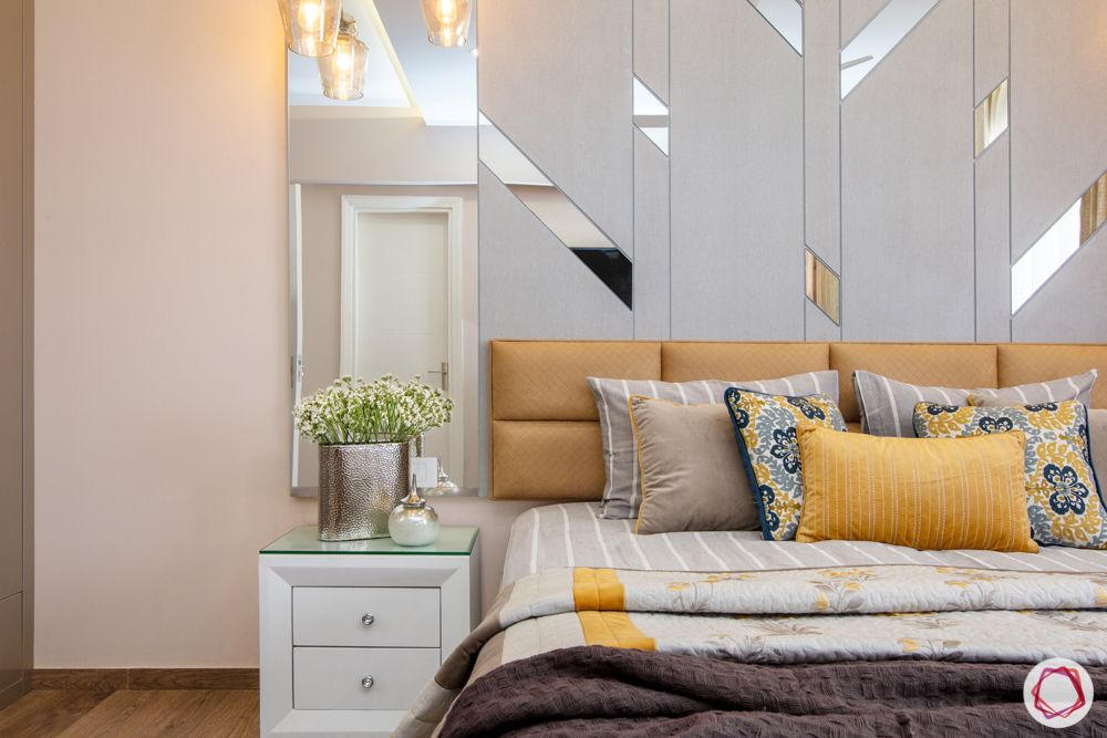 bedroom accent wall-mirror panels wall-yellow headboard-bedside table