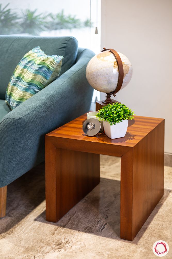 home renovation mumbai-globe-planters-wooden side table-blue couch-blue cushion