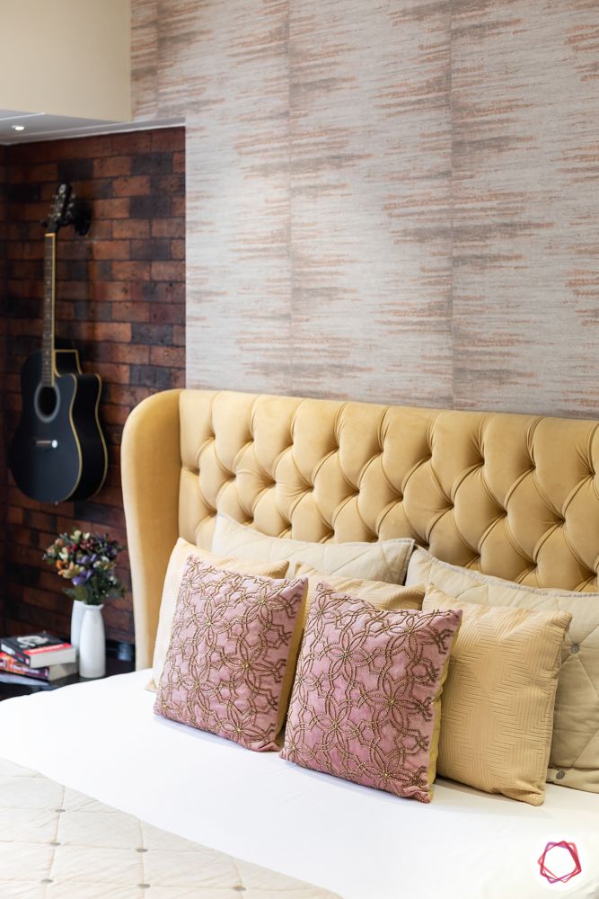 beige headboard-textured wallpaper-brick tiled wall-guitar