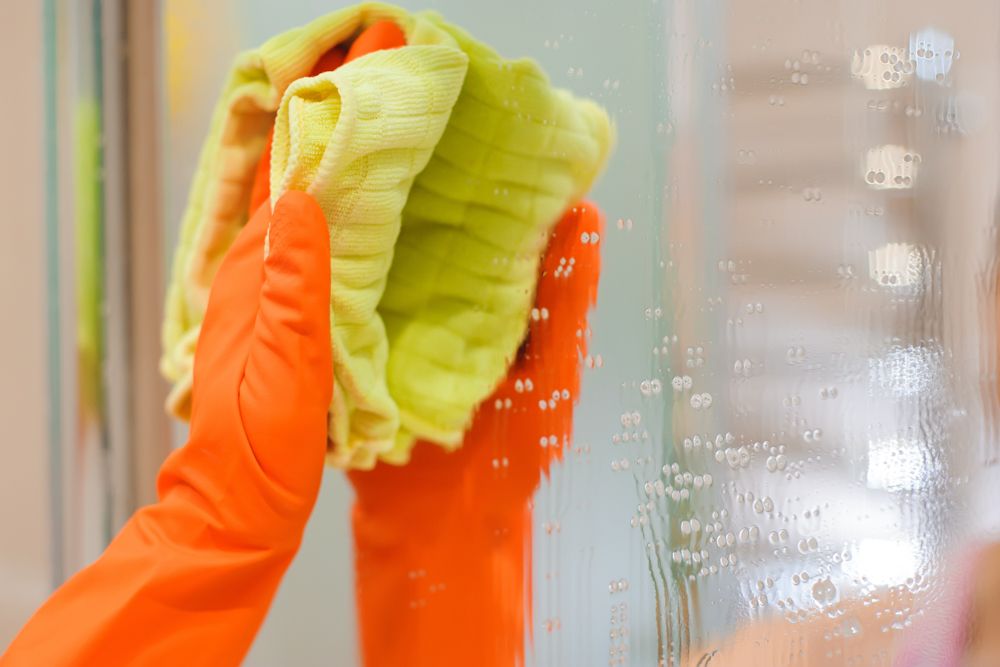 how to clean bathroom-orange glove-mirror