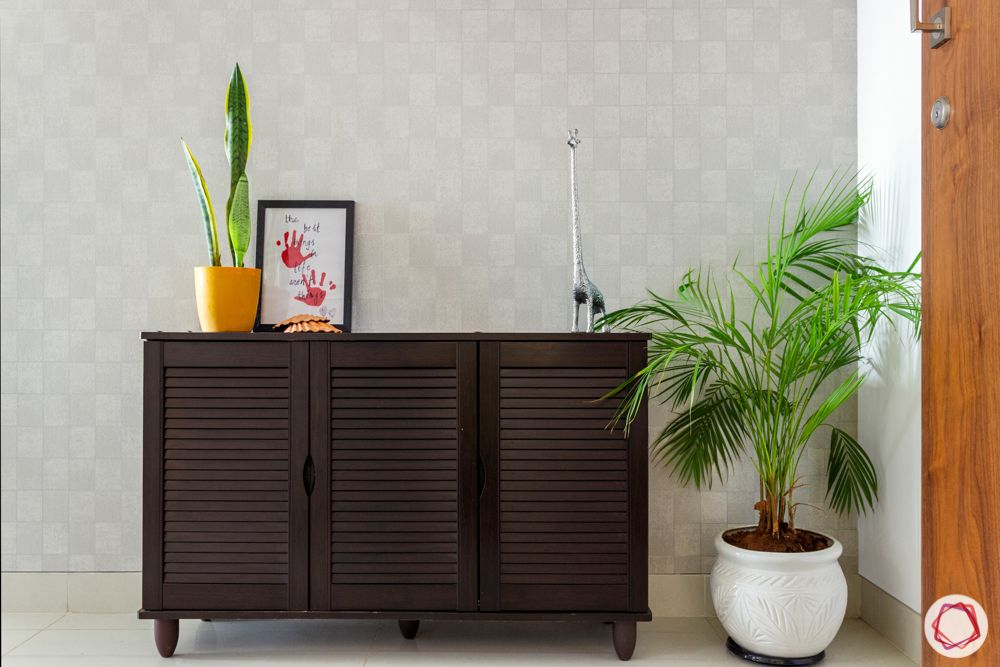 living room-shoe cabinet-planters-checked wallpaper
