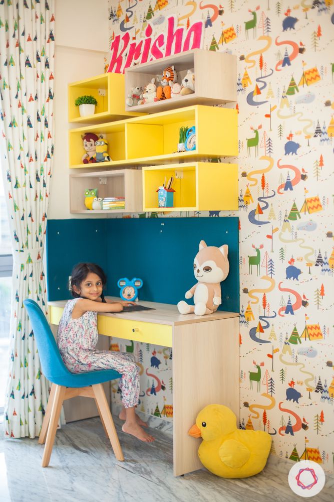 home in pune-yellow study table-printed wallpaper-display shelves