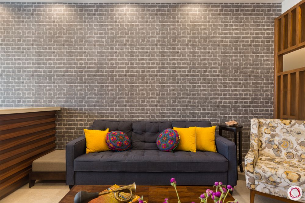 4 bhk apartment-living room-wooden partition-pattern cushions-grey sofa