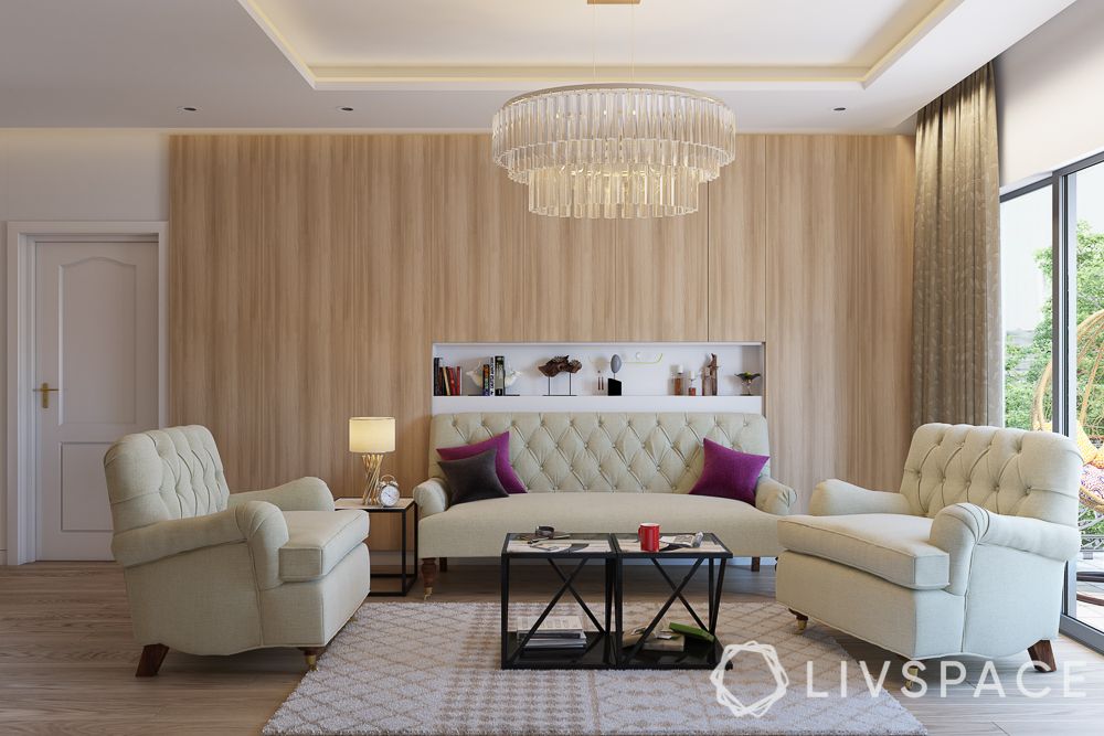 cream-quilted-sofa-wooden-accent-wall-glass-chandelier