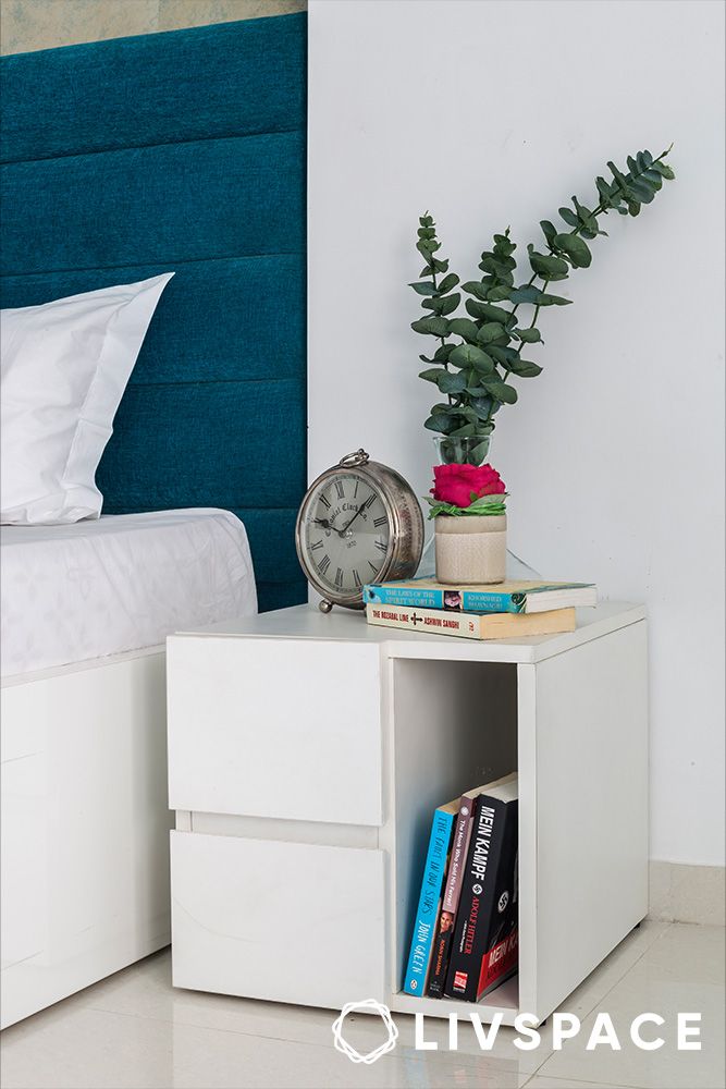 white-side-table-with-books-in-a-guest-bedroom