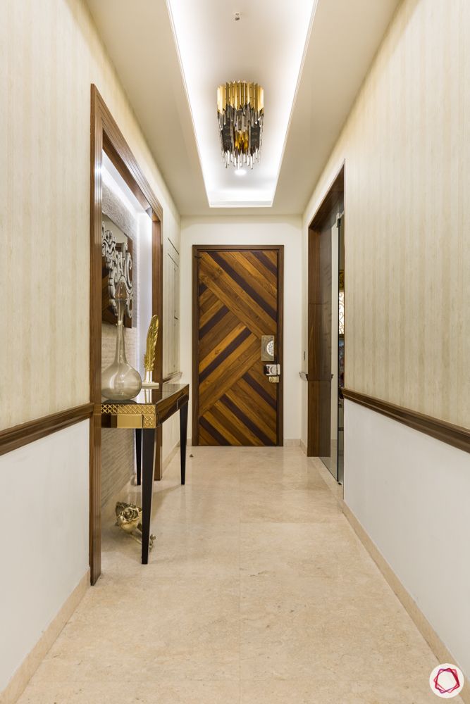 DLF-capital-greens-foyer-false-ceiling-wall-niche-chandelier-wooden-cladding 