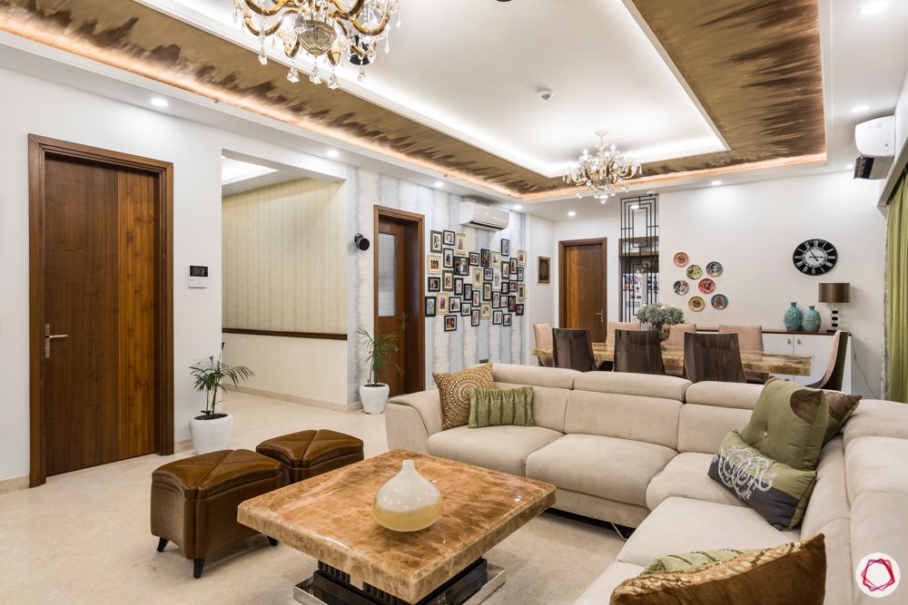 DLF-capital-greens-living-room-fiery-textured-paint-sofas-ottoman