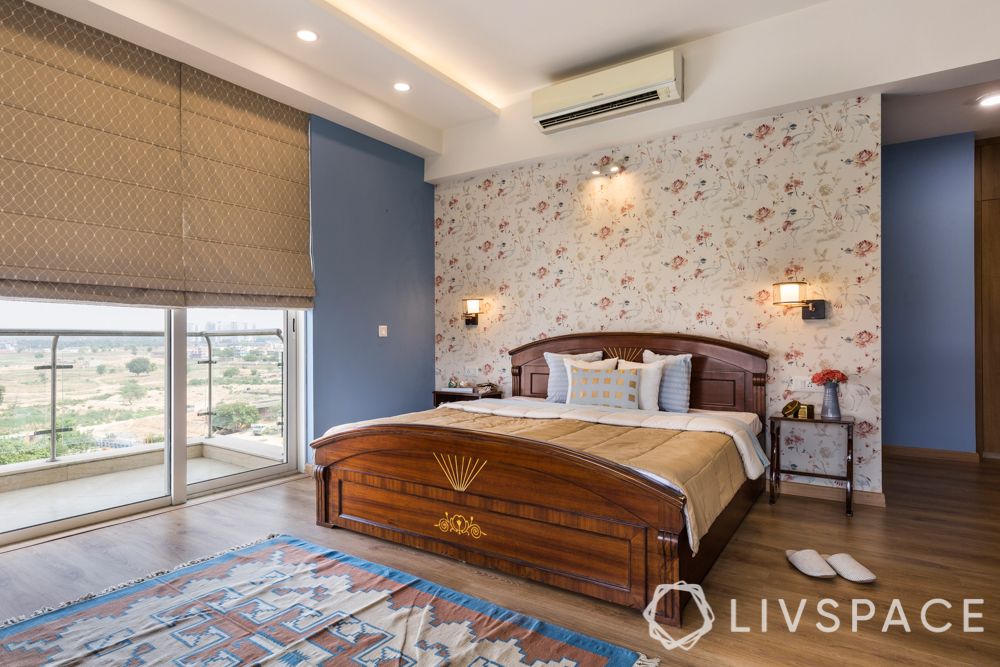 wooden-bed-wooden-flooring-floral-wallpaper-blue-walls-blinds