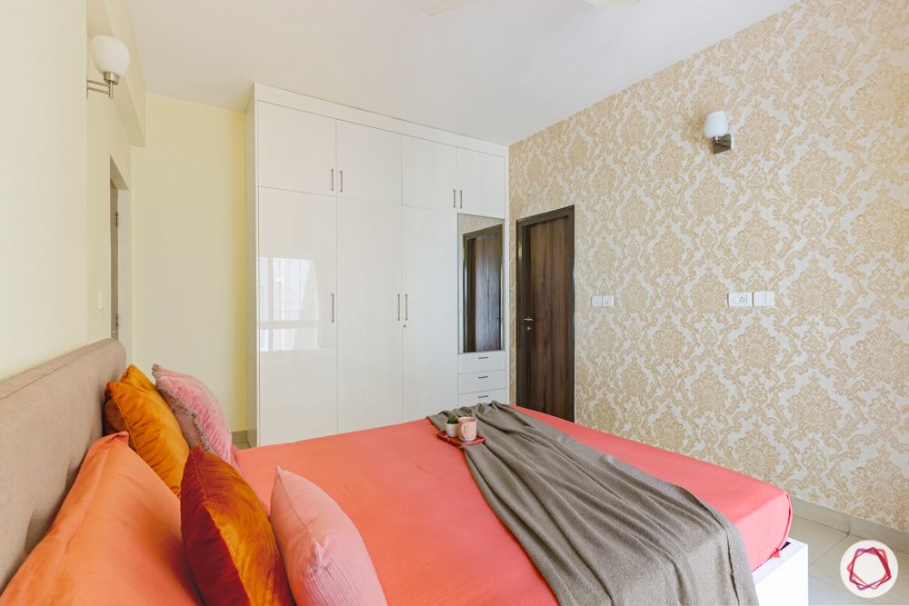 bedroom-orange-sheets-wall-niche-wardrobe-dresser-mirror